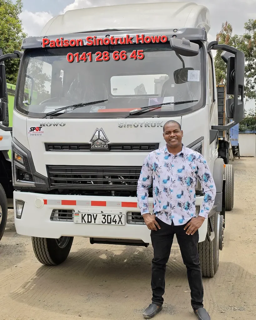 A man in a patterned shirt stands in front of a new white Sinotruk Howo M3 Rigid 5200MM, registration KDY 304X, one of three trucks delivered to Shechem Events